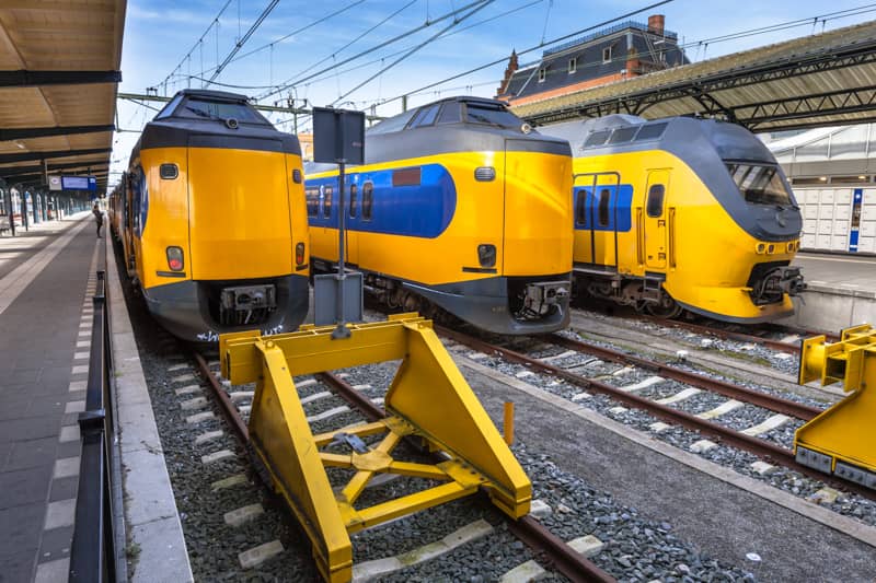 Multiple NS Trains stopping at a Train Station in the Netherlands