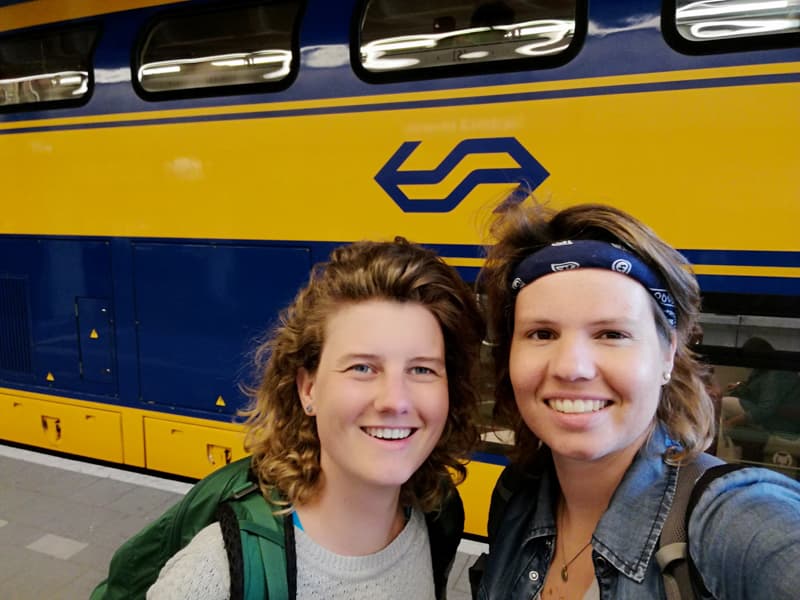 Kelly and Nanet in front of an NS Train on a station in the Netherlands