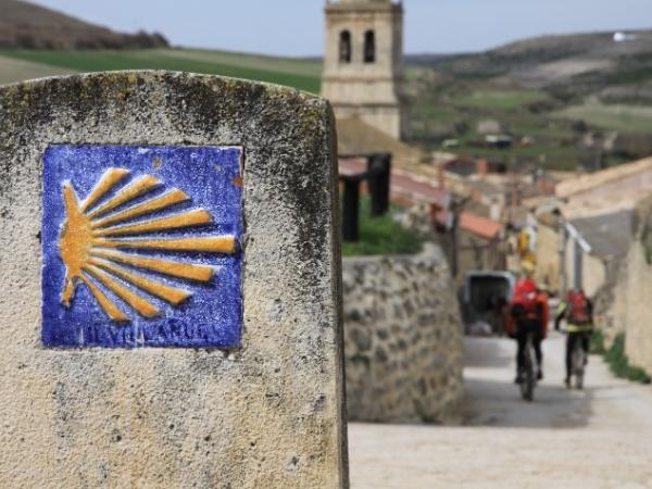 Cycling in Spain along a Camino de Santiago sign on the road